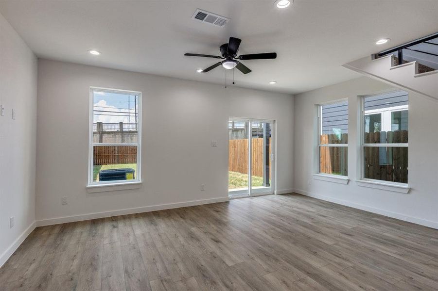 Spare room featuring light wood-type flooring, a ceiling fan, and recessed lighting Spare room featuring light wood-type flooring, a ceiling fan, and recessed lighting