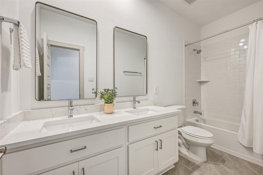 The secondary bath offers plenty of space to share with dual undermount sinks, generous vanity storage, sleek fixtures and a tiled tub/shower combination. The secondary bath offers plenty of space to share with dual undermount sinks, generous vanity storage, sleek fixtures and a tiled tub/shower combination.