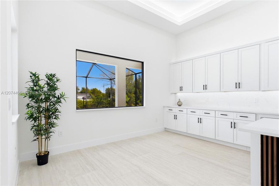 DINING ROOM features a soaring volume ceiling, recessed LED lighting & LARGE PICTURE WINDOW to screened lanai, pool/spa & waterfront. DINING ROOM features a soaring volume ceiling, recessed LED lighting & LARGE PICTURE WINDOW to screened lanai, pool/spa & waterfront.