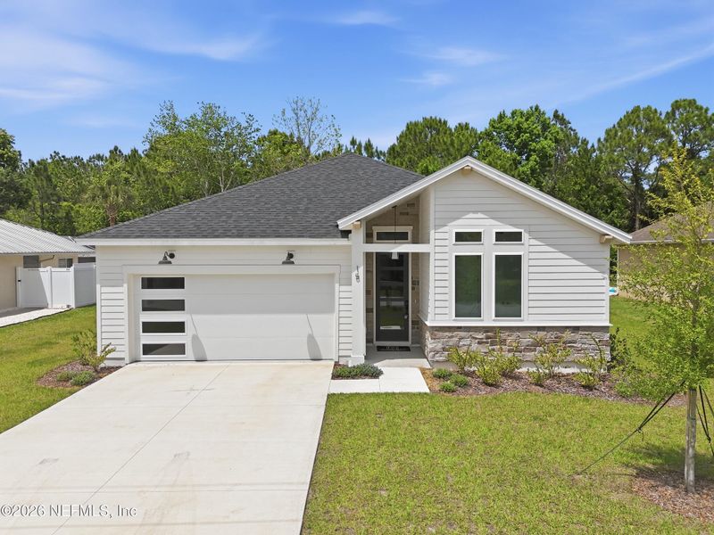 Front exterior of a new home in Palm Coast Homes, Palm Coast, FL, highlighting curb appeal (Image 26).