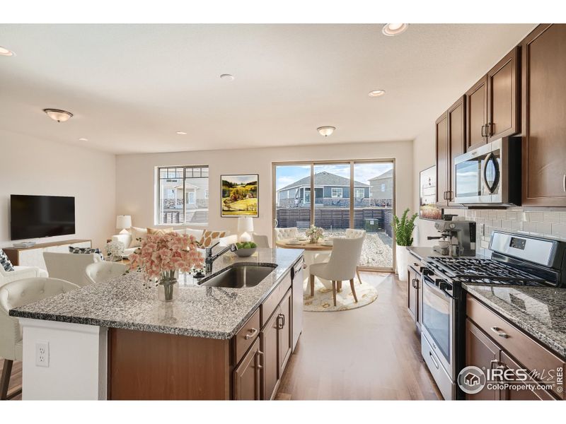 Home Under Construction. Photos are of the same Alpine floorplan, different home. Kitchen with upgraded stainless steel appliances. Home Under Construction. Photos are of the same Alpine floorplan, different home. Kitchen with upgraded stainless steel appliances.