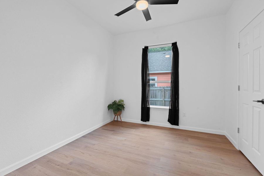 Spare room with ceiling fan and light wood-style flooring