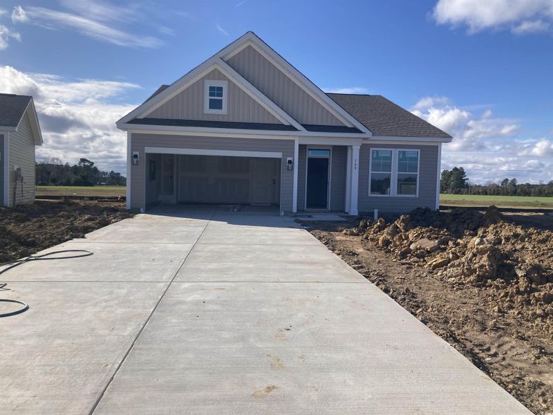 View of front of property featuring driveway, a garage, and board and batten siding