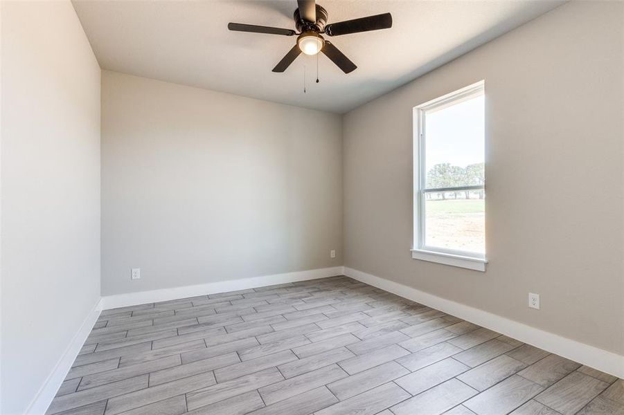 Empty room with light wood-type flooring and ceiling fan