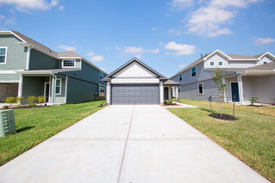 Front exterior of a new home in Ridgeland Hills, Willis, TX, highlighting curb appeal (Image 2).