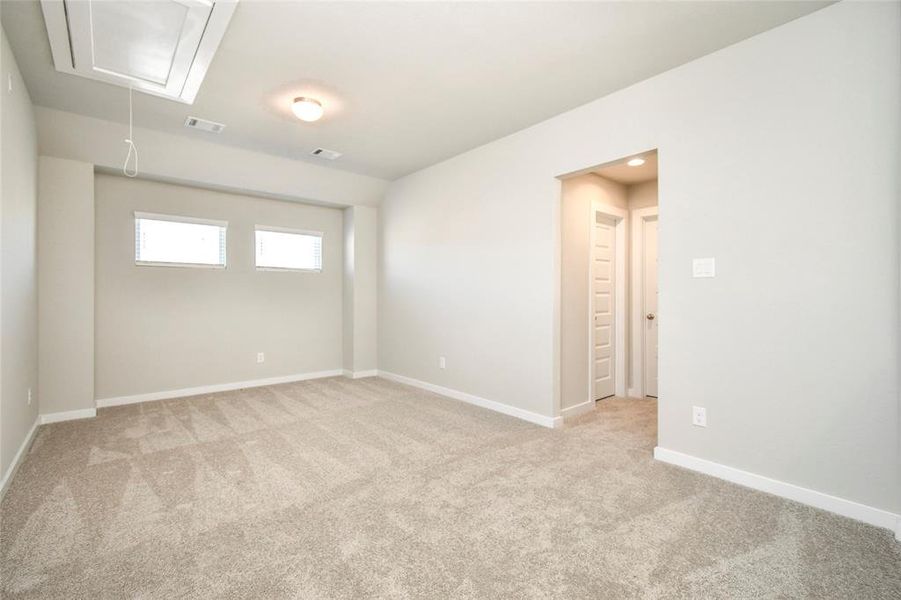 Come upstairs and enjoy a day of leisure in this fabulous game room! This is the perfect hangout spot or adult game room! Features plush carpet, high ceilings, custom paint and windows for plenty of natural light.