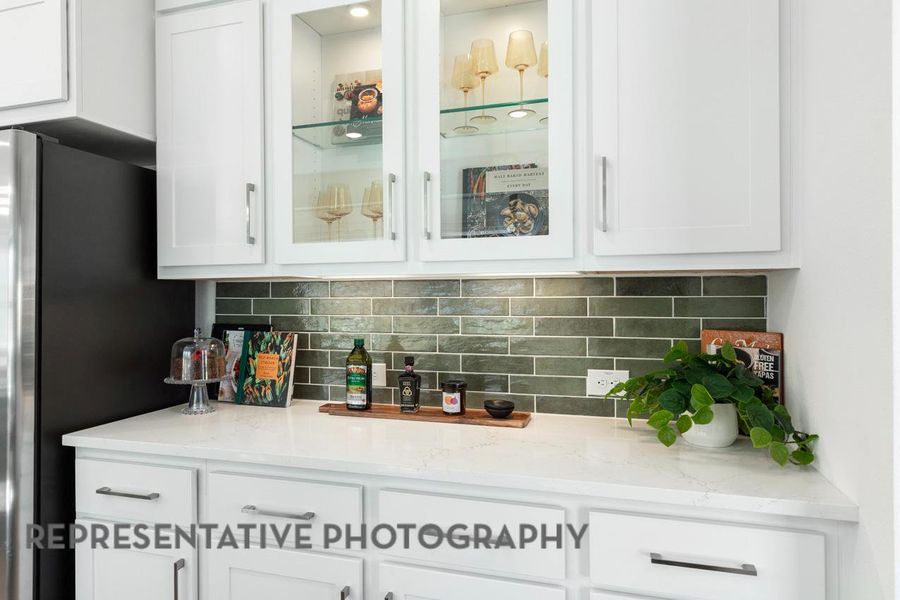 Bar featuring freestanding refrigerator and decorative backsplash Bar featuring freestanding refrigerator and decorative backsplash