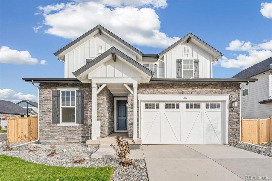 Front exterior of a new home in Windsong, Thornton, CO, highlighting curb appeal (Image 21).