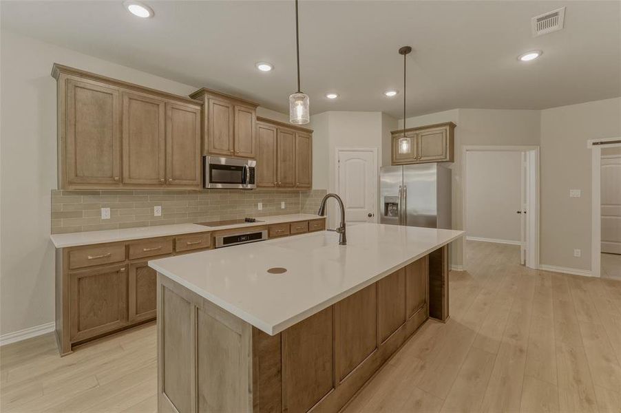 Expansive kitchen island with a light-toned countertop and integrated sink