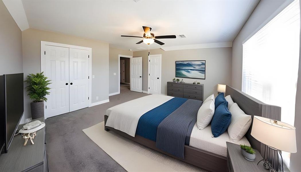 Bedroom with carpet, ceiling fan, and two closets Bedroom with carpet, ceiling fan, and two closets