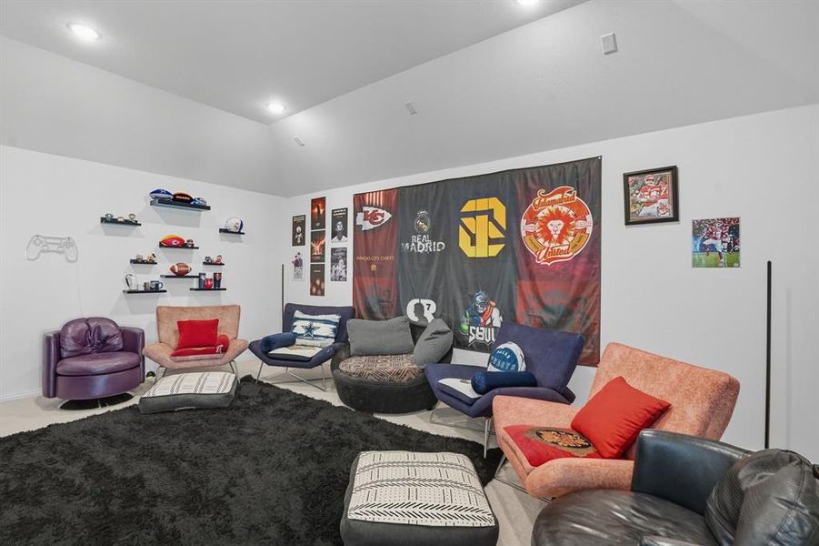 Living room with vaulted ceiling, recessed lighting, and tile patterned flooring