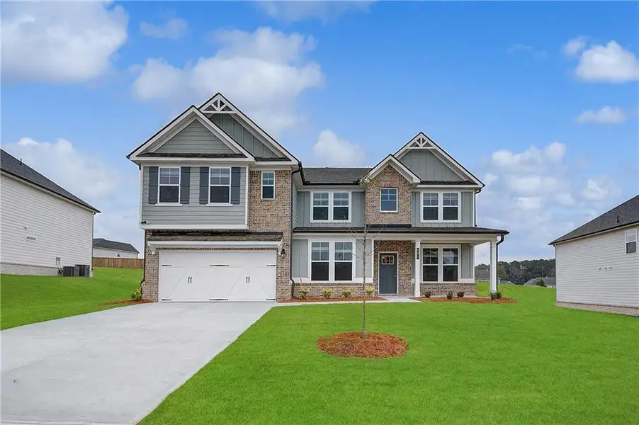 Front exterior of a new home in Grandview at Millers Mill, Stockbridge, GA, highlighting curb appeal (Image 2). Front exterior of a new home in Grandview at Millers Mill, Stockbridge, GA, highlighting curb appeal (Image 2).