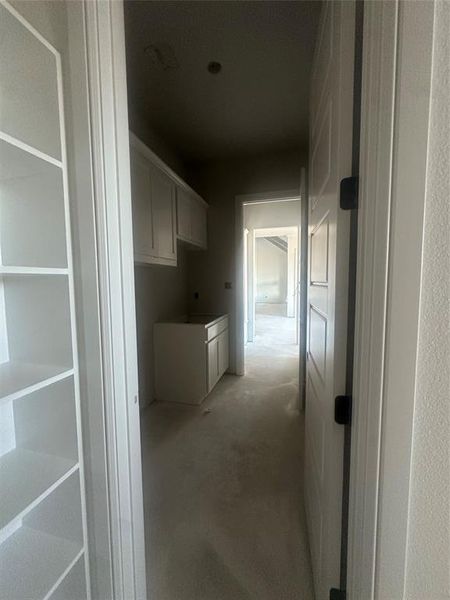 Primary closet conveniently connects to the utility room