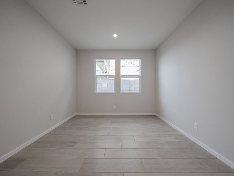 A room with a wood floor and a window.