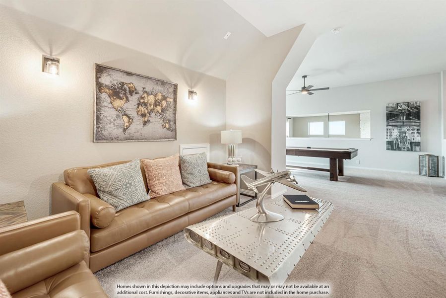 Open living area with vaulted ceiling, leather sofa, and pool table in adjacent game room