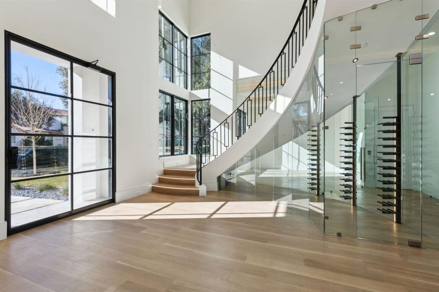 Wine area with a high ceiling and wood finished floors