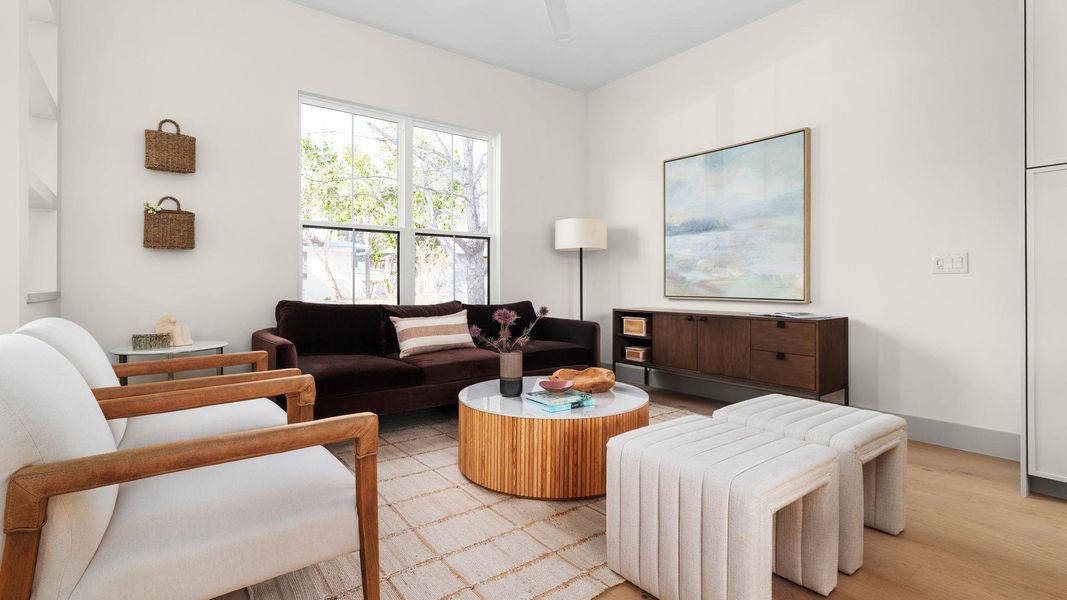 Living room with light wood-style floors and baseboards