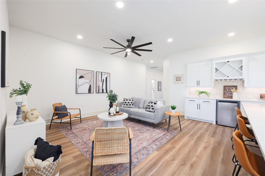 Living room featuring a dry bar, recessed lighting, light wood finished floors, and ceiling fan