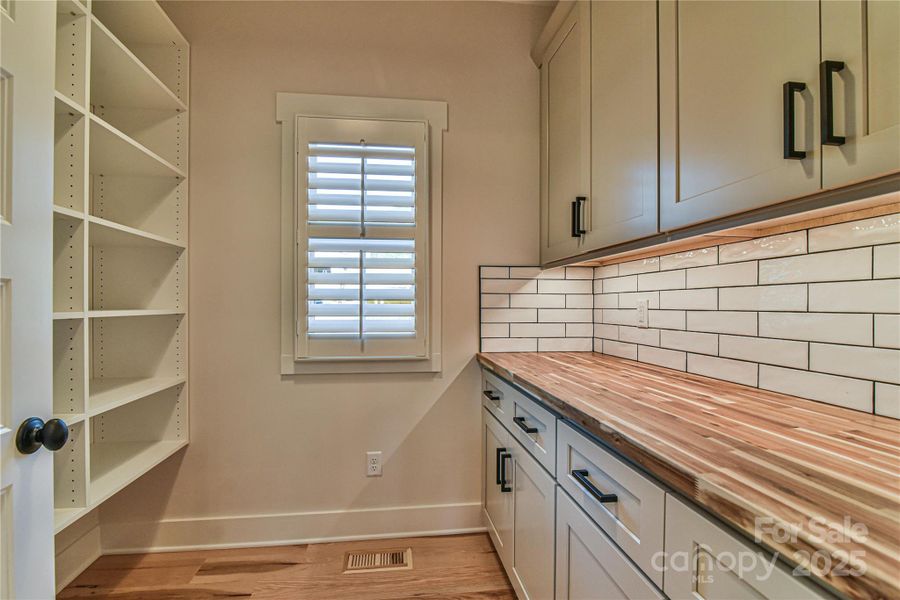 Butler pantry with lots of storage.Similar photo.