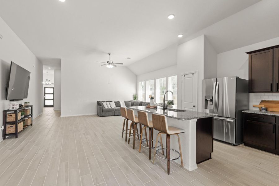 This stunning kitchen is perfect for everyday life as well as entertaining family and friends! This kitchen conveniently connects to the dining area and living room for easy entertaining