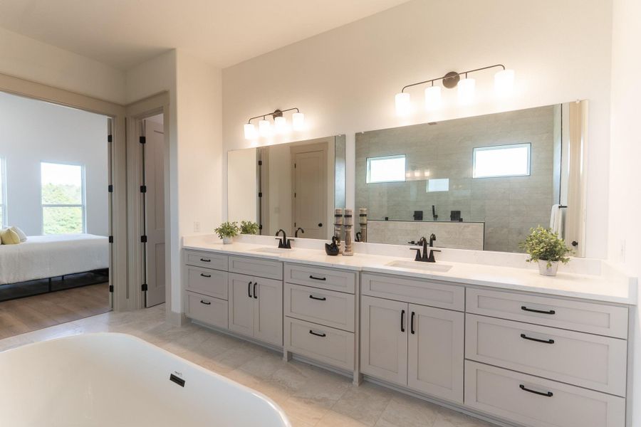 Bathroom with double vanity, a freestanding tub, ensuite bathroom, and a walk in shower Bathroom with double vanity, a freestanding tub, ensuite bathroom, and a walk in shower