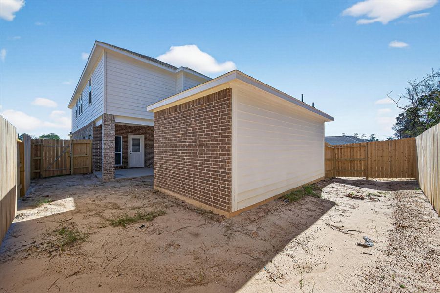 Exterior details and patio area of a home in Enclave at Willis, Willis (Image 4).