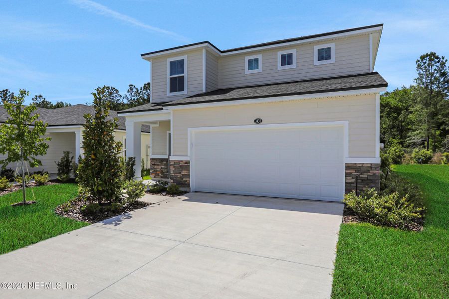 Front exterior of a new home in Amberly, Green Cove Springs, FL, highlighting curb appeal (Image 21).