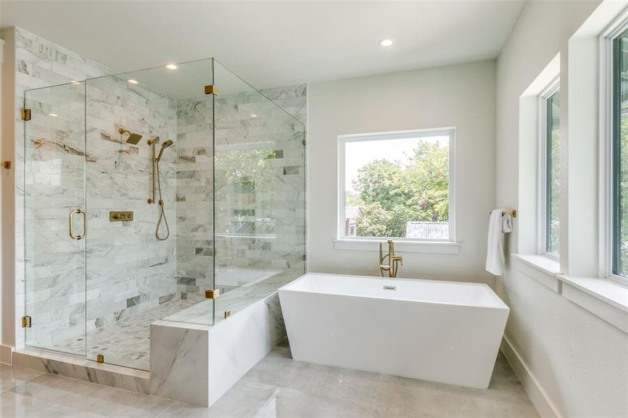 Bathroom with plus walk in shower and tile patterned flooring