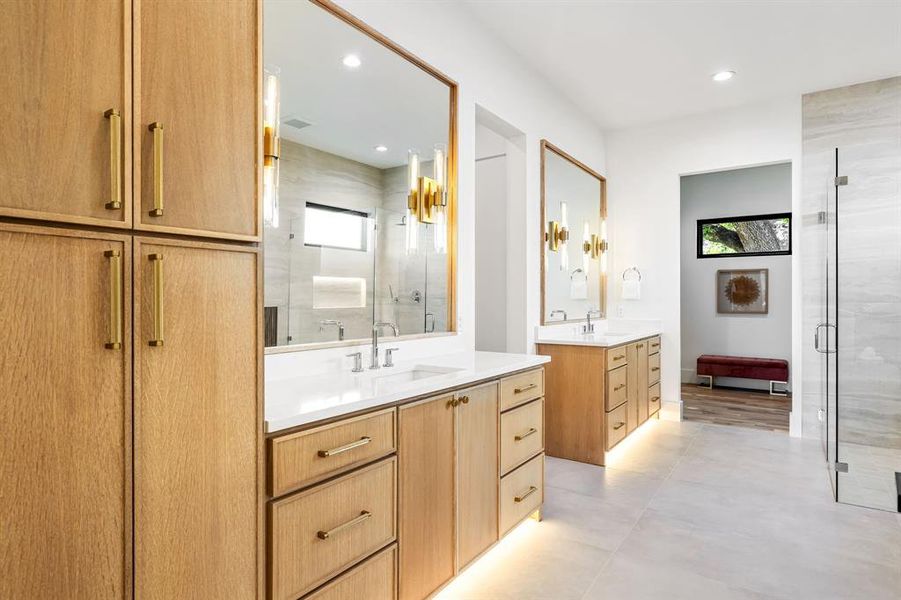 Bathroom featuring a shower stall, two vanities, plenty of natural light, and recessed lighting Bathroom featuring a shower stall, two vanities, plenty of natural light, and recessed lighting
