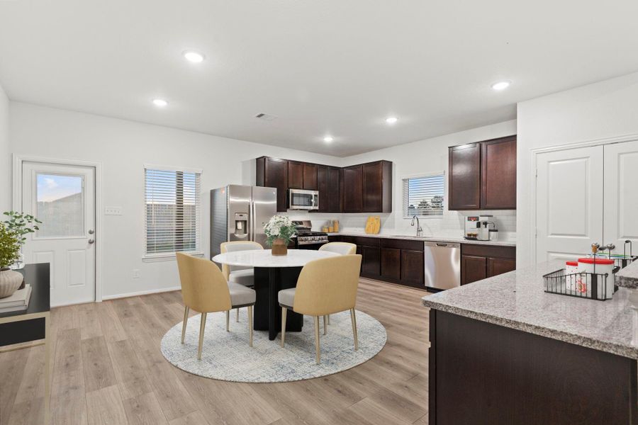 The virtually staged dining area sits just off the kitchen and provides plenty of natural light from the rear windows and door leading to the backyard. It’s a bright and cheerful space perfect for family meals or casual get-togethers.