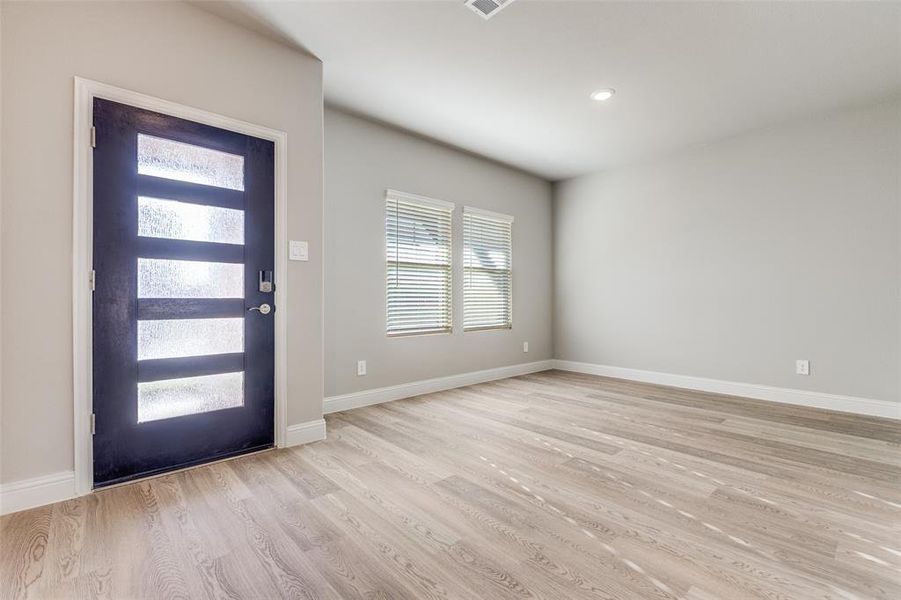 Entrance foyer with light wood-style flooring and recessed lighting Entrance foyer with light wood-style flooring and recessed lighting