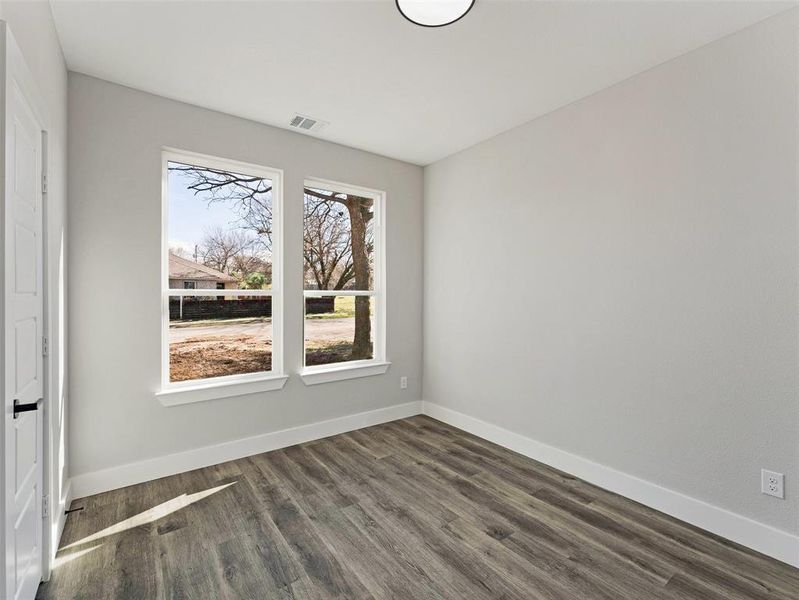 Spare room with dark hardwood / wood-style flooring