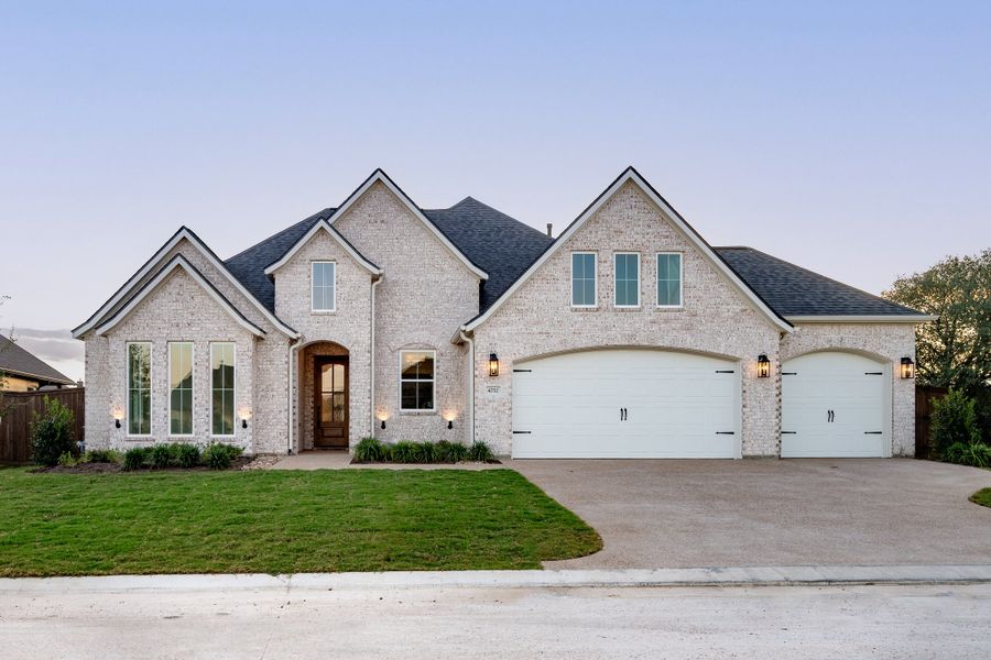 Front exterior of a new home in Greens Prairie Reserve, College Station, TX, highlighting curb appeal (Image 30). Front exterior of a new home in Greens Prairie Reserve, College Station, TX, highlighting curb appeal (Image 30).