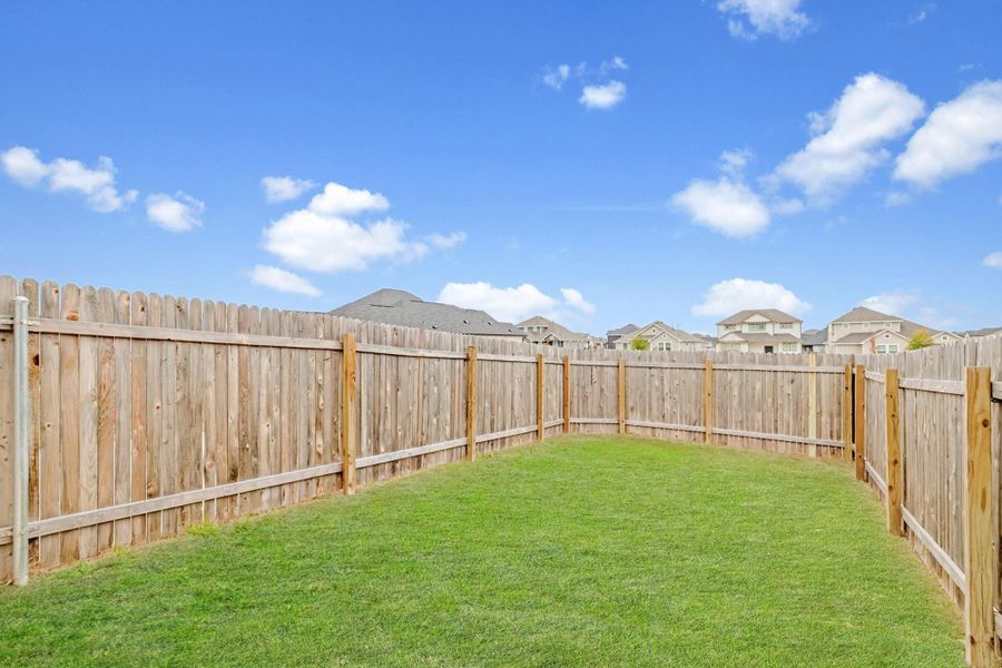 Fenced backyard with a residential view