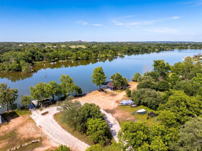 Mature trees frame a quiet shoreline with private water access and calm, open views.