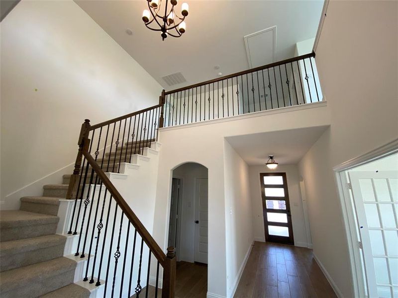 Elegant staircase with wrought iron spindles & ORB chandelier Elegant staircase with wrought iron spindles & ORB chandelier