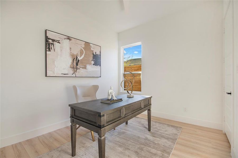 Office area with light wood-style floors and baseboards Office area with light wood-style floors and baseboards
