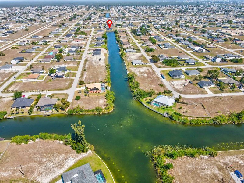 Drone / aerial view with a water view and a residential view