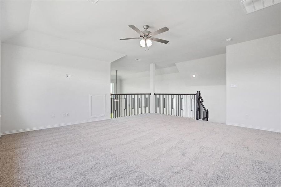 Spare room featuring ceiling fan and carpet floors