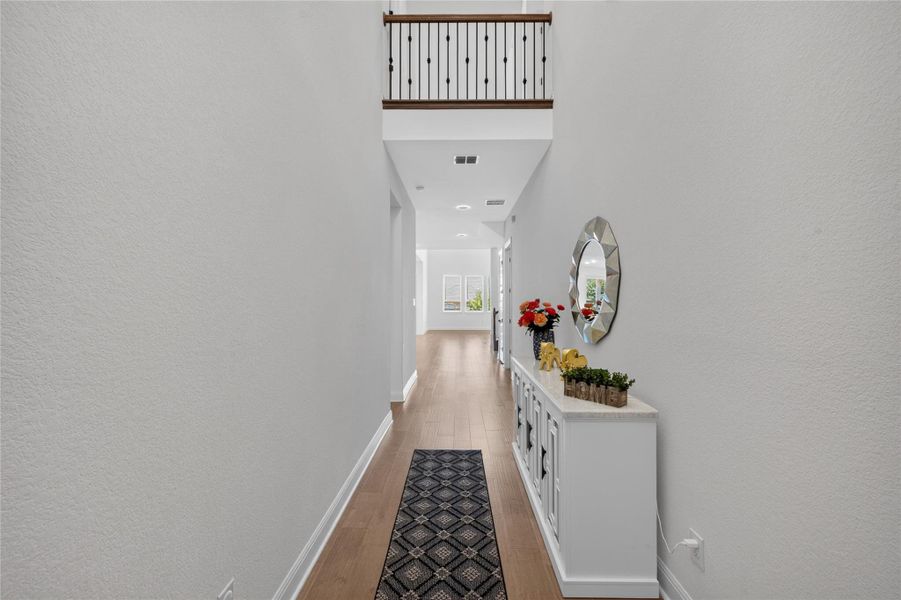 A soaring ceiling rises above this welcoming entryway, accented by warm wood flooring. A soaring ceiling rises above this welcoming entryway, accented by warm wood flooring.