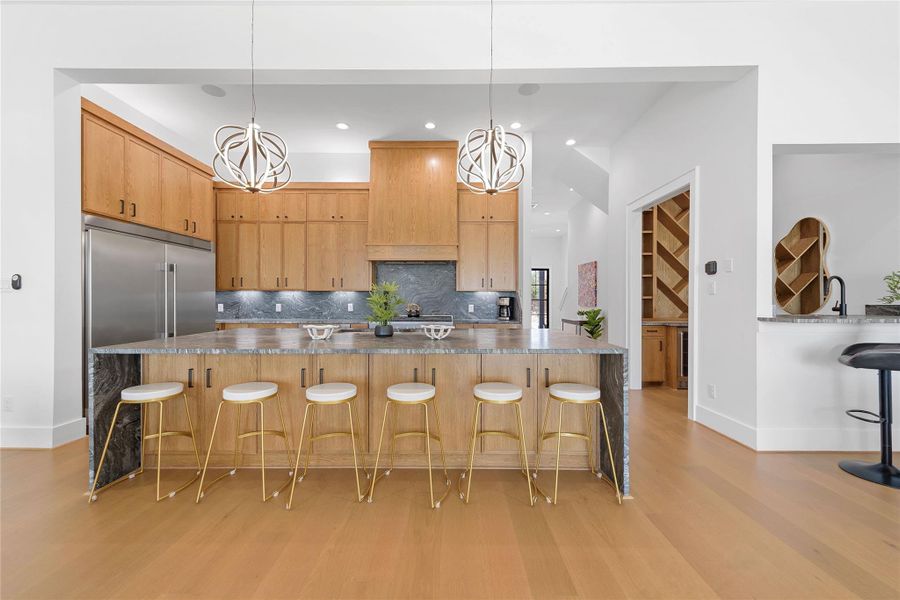 This chef’s kitchen is a showstopper—featuring a waterfall-edge island, double built-in refrigerator, and designer lighting. The open layout frames sweeping Hill Country views and flows effortlessly into the dining and living areas, perfect for entertaining at Canyon Lake.