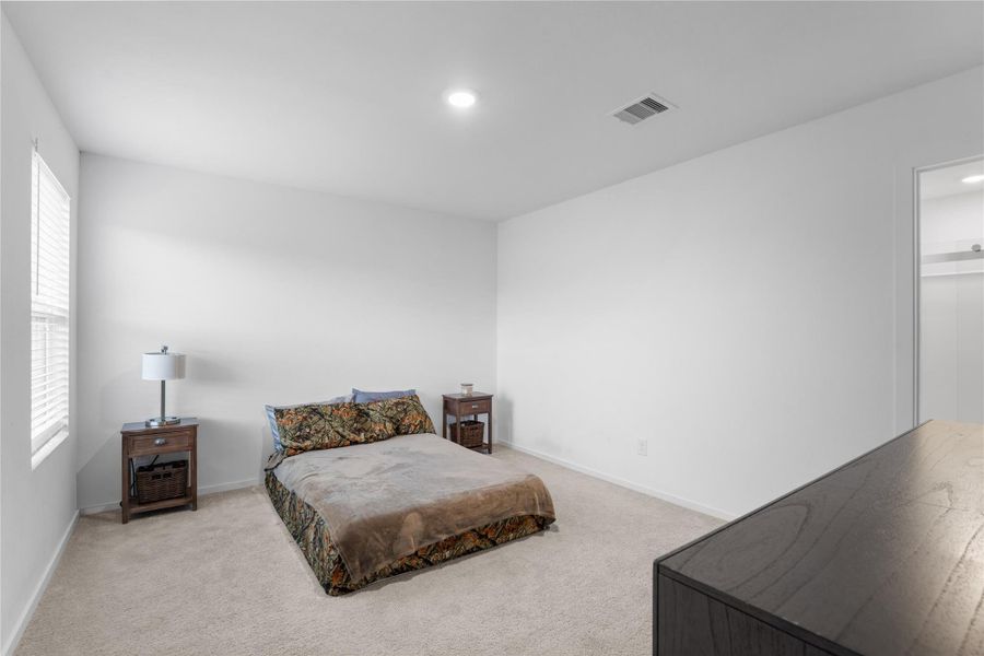 Well-maintained carpet adds a comfortable feel to the primary bedroom.