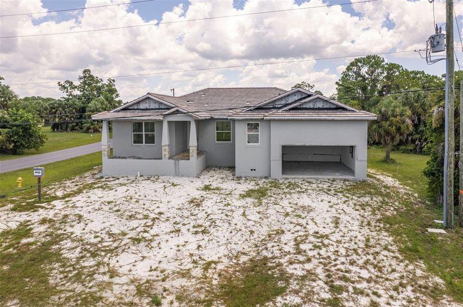 Front exterior of a new home in , Punta Gorda, FL, highlighting curb appeal (Image 1). Front exterior of a new home in , Punta Gorda, FL, highlighting curb appeal (Image 1).