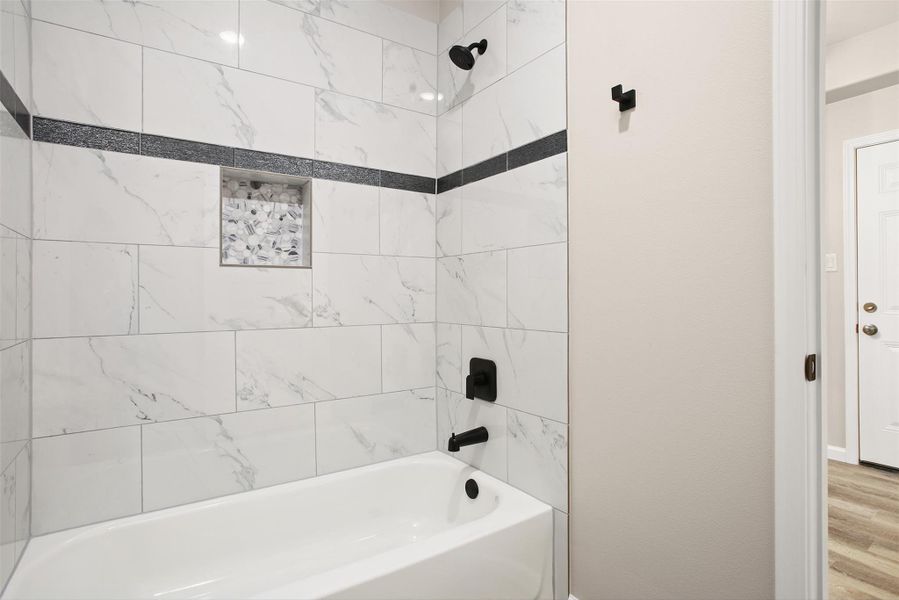 Tub/shower combo in the downstairs primary bedroom