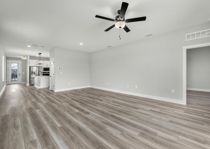 Spacious family room with the kitchen in the distance