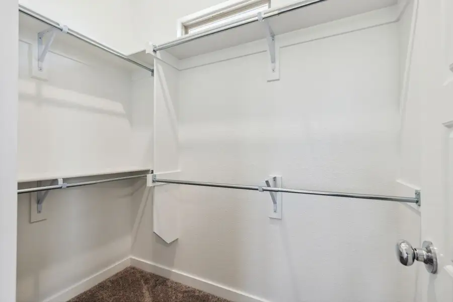 Primary Closet in the Ash home plan by Trophy Signature Homes – REPRESENTATIVE PHOTO Primary Closet in the Ash home plan by Trophy Signature Homes – REPRESENTATIVE PHOTO