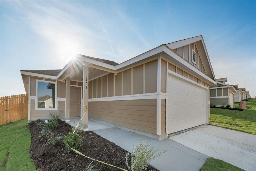 View of property exterior with a garage and a yard