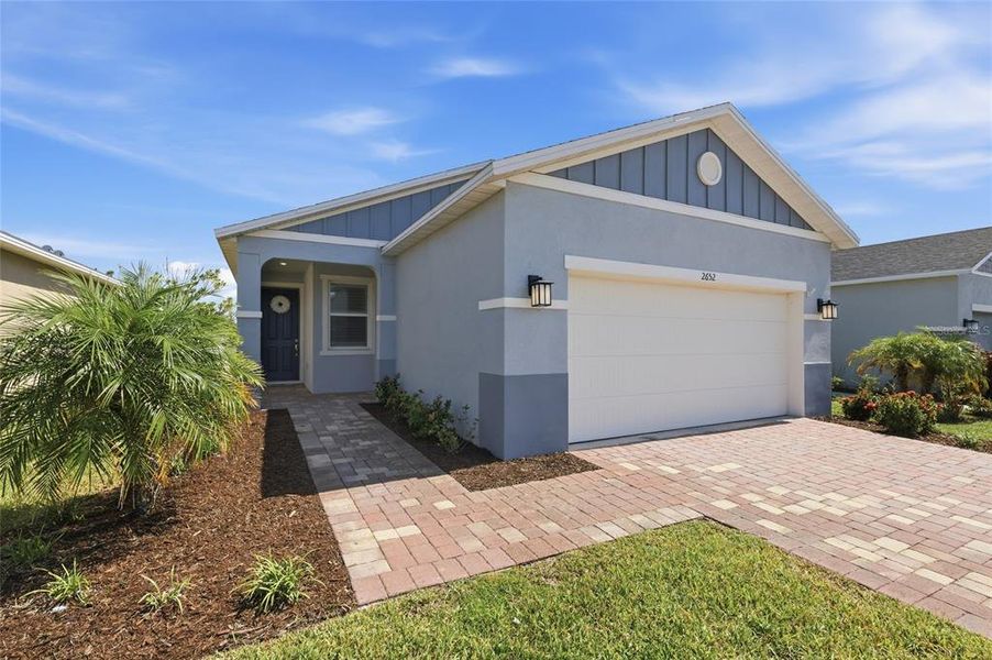 Front exterior of a new home in Heron Bay, Palmetto, FL, highlighting curb appeal (Image 25). Front exterior of a new home in Heron Bay, Palmetto, FL, highlighting curb appeal (Image 25).