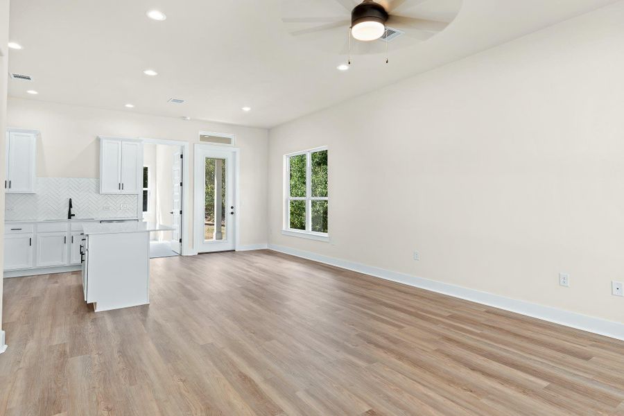 Unfurnished living room with recessed lighting, light wood-style floors, and ceiling fan