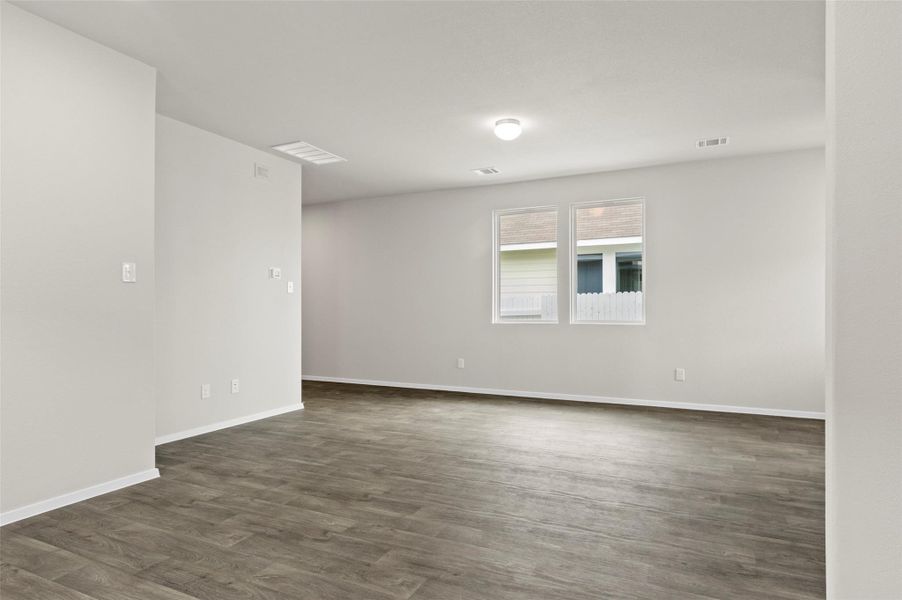 Unfurnished room with dark wood finished floors and baseboards